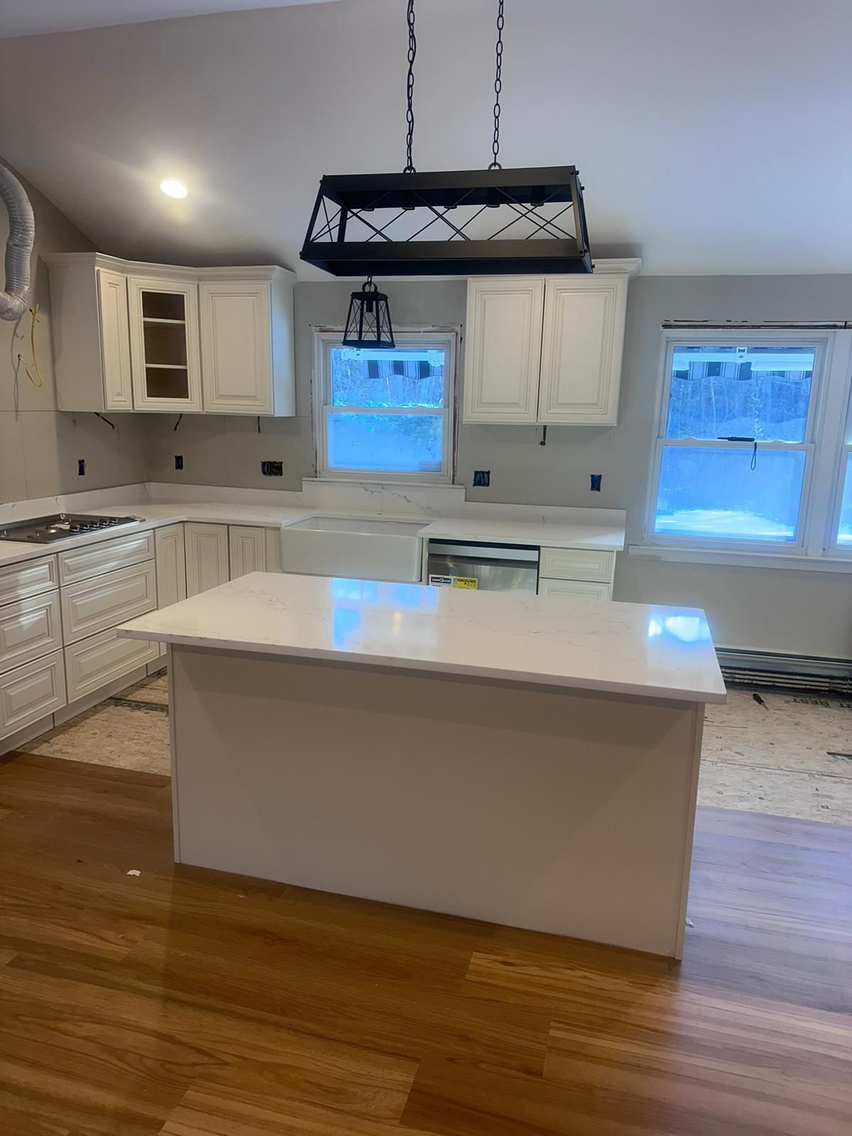 Contemporary kitchen design with white cabinets and a black countertop, representing Marble and Granite Services